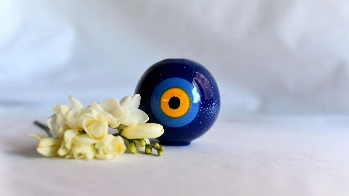 A person cleansing a home with salt and herbs to remove the evil eye and negative energy.