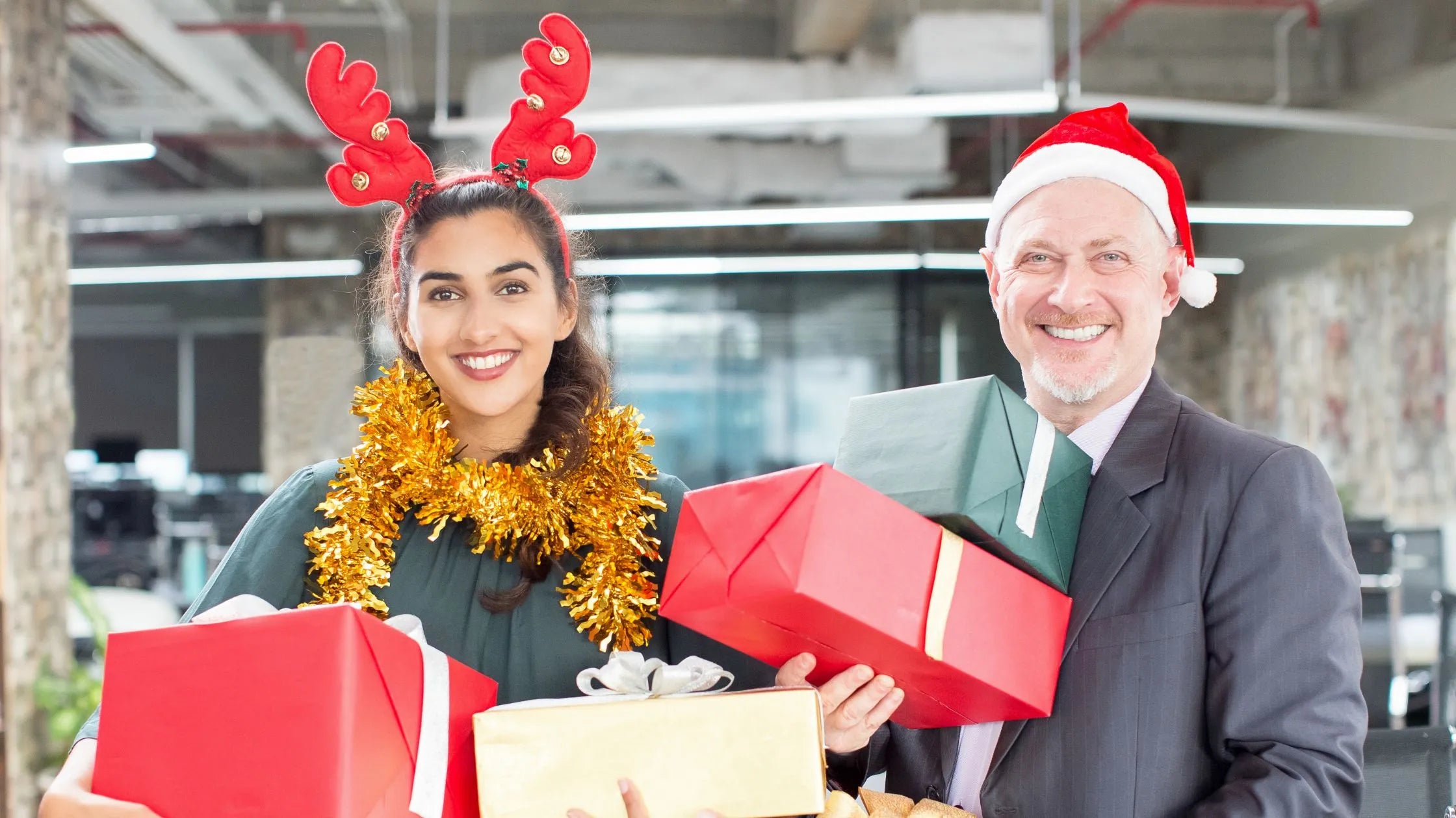 A person smiling while writing a thank-you note for a Secret Santa gift, surrounded by festive decorations.