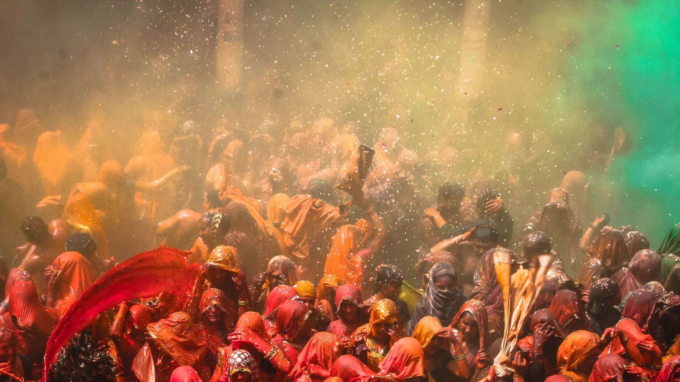 Vibrant scene of Braj Holi celebration with colorful powders, joyful participants, and traditional festivities.