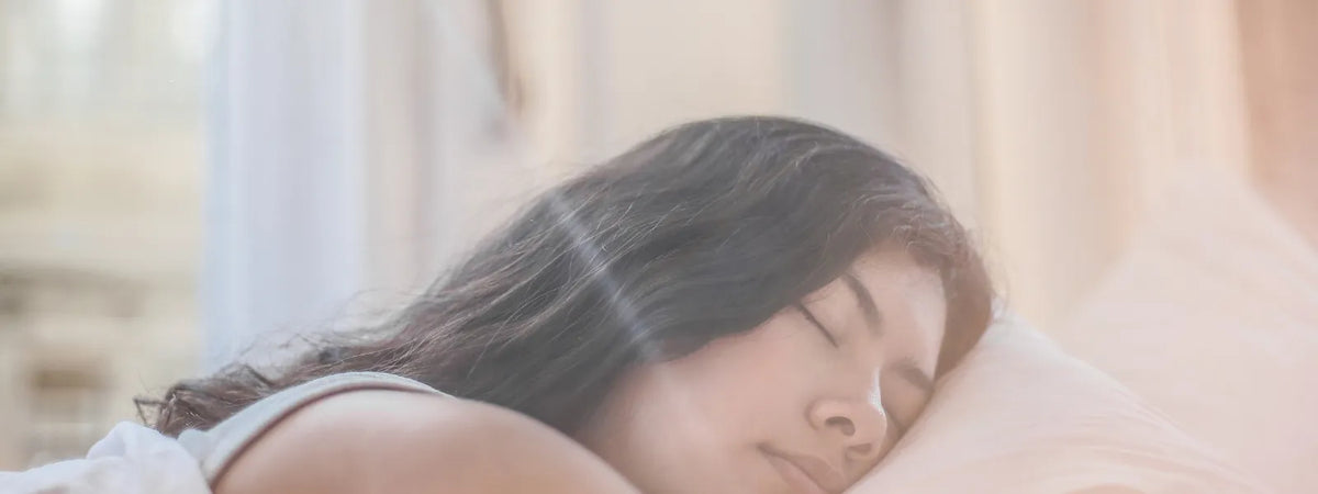 A person struggling to sleep, showing signs of insomnia like tossing and turning in bed.